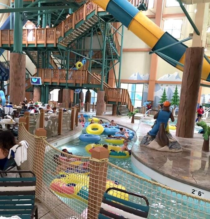 Travelers enjoying an indoor waterpark lazy river